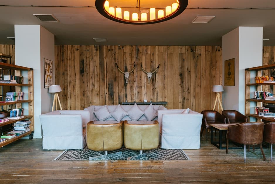 Rooms Hotel Kazbegi — the building set against the Caucasus Mountains
