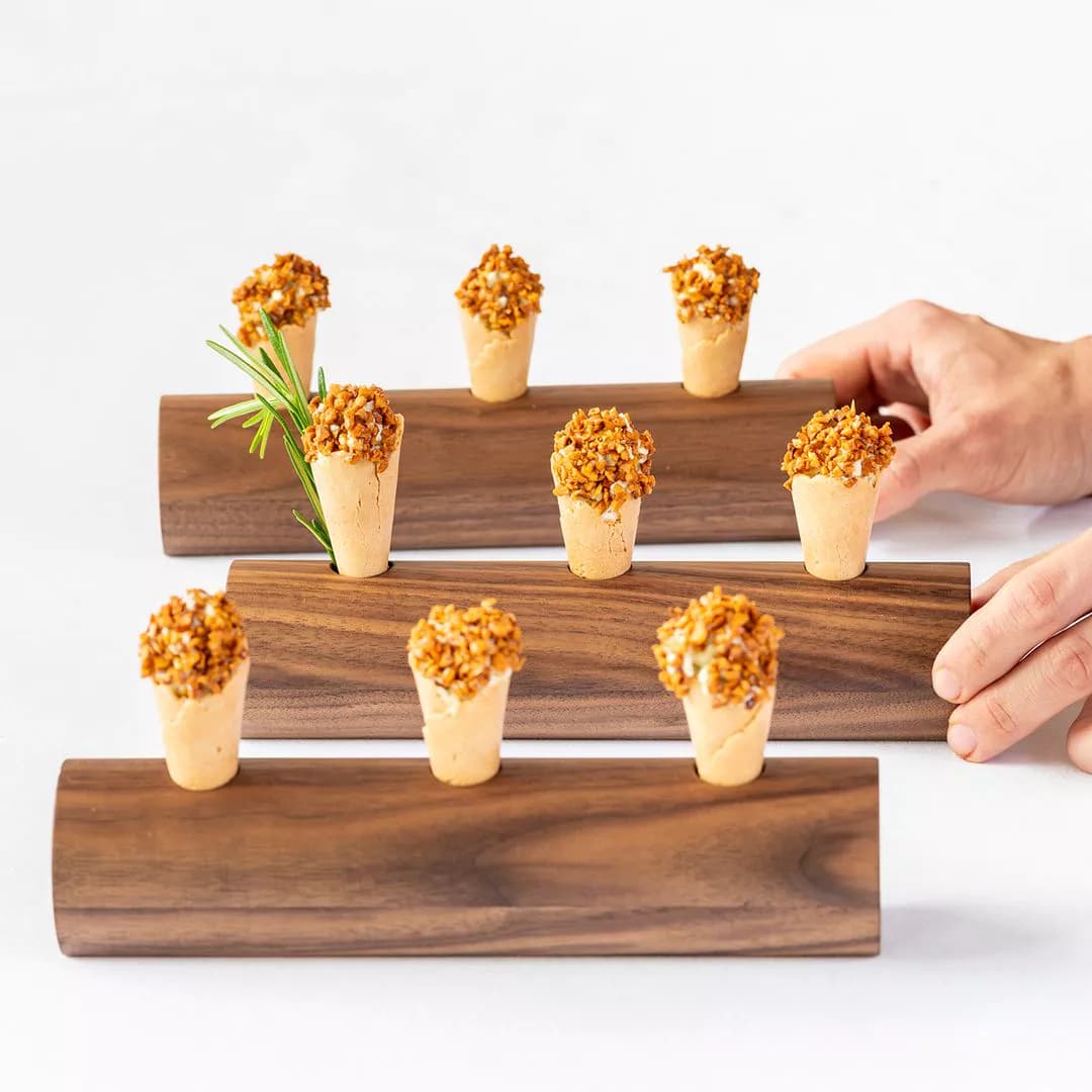 Sissi — Amuse-bouche cones on wooden log stands, Merano