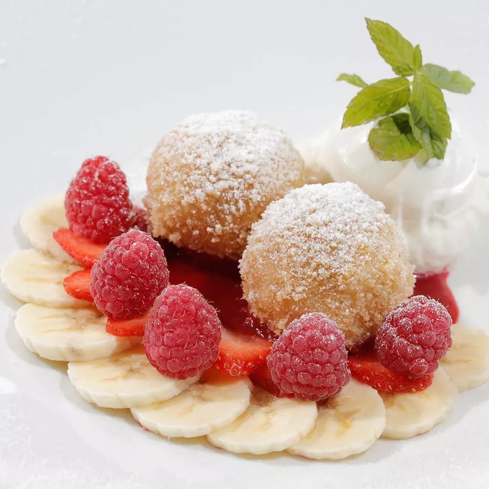 Oberlechner — Germknödel with berries and cream, South Tyrolean classic